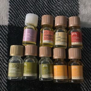 ASSORTED home fragrance oils from the body shop - 9 bottles - musky, fruity